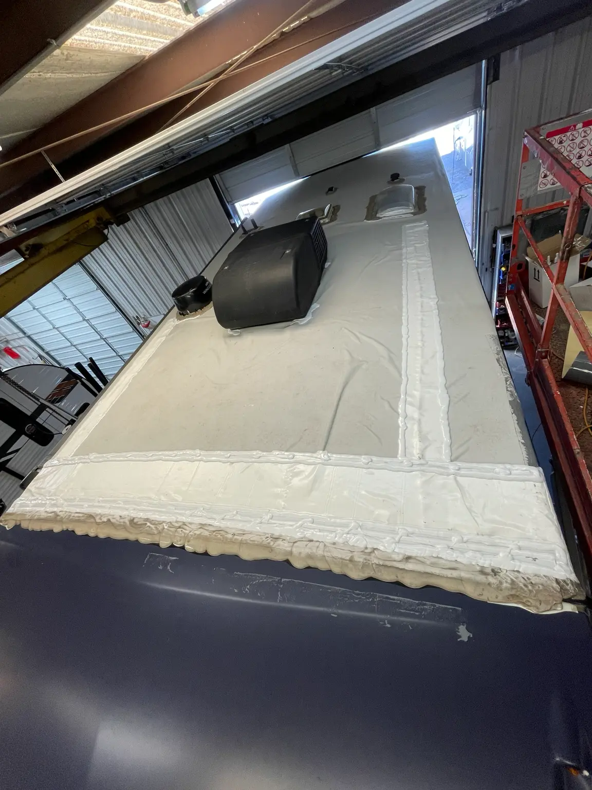 Repaired RV roof section with finished membrane and sealing