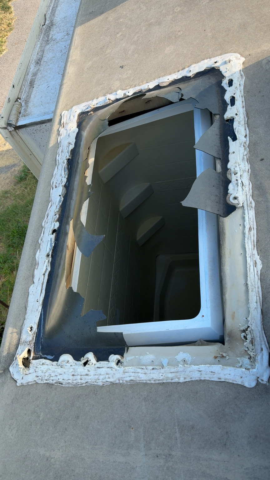 Damaged RV skylight and roof opening before replacement