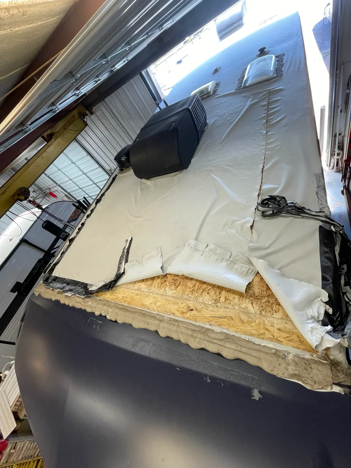 Damaged RV roof section opened for structural repair