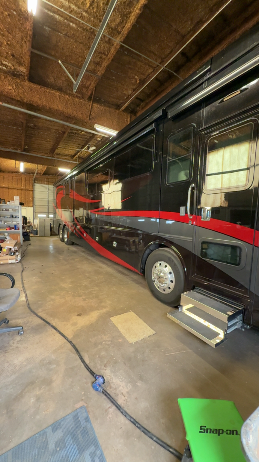 Motorcoach parked inside the Elk City RV Service shop for repair work