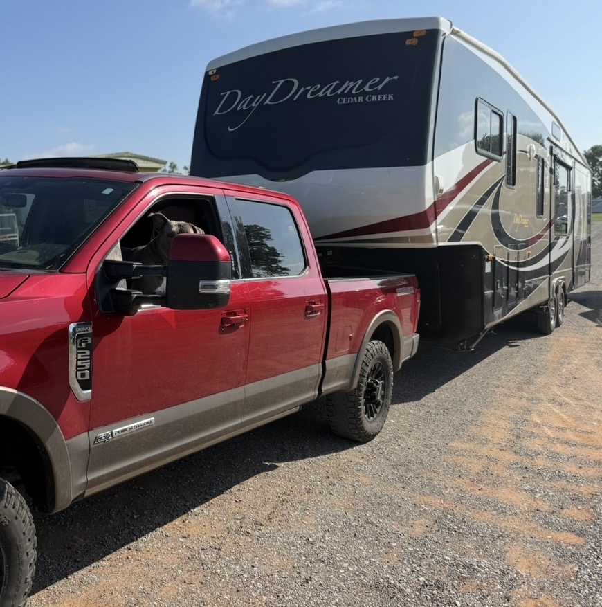 Truck towing a fifth-wheel RV at Elk City RV Service